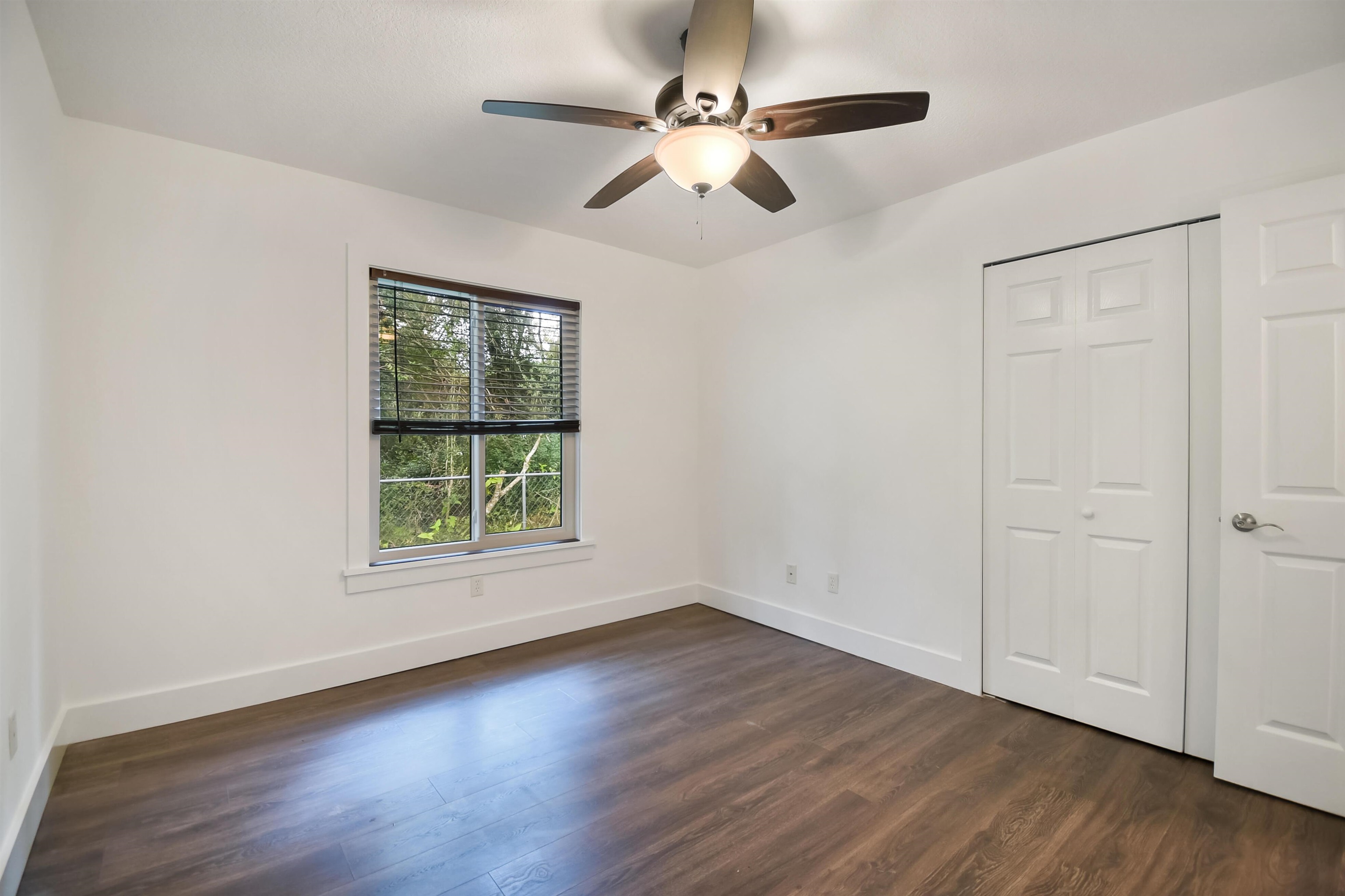 497 Pyrus Street St. Augustine, FL 32080 - Photo 19 of 36 Unfurnished bedroom featuring dark wood-style flooring, ceiling fan, and a closet