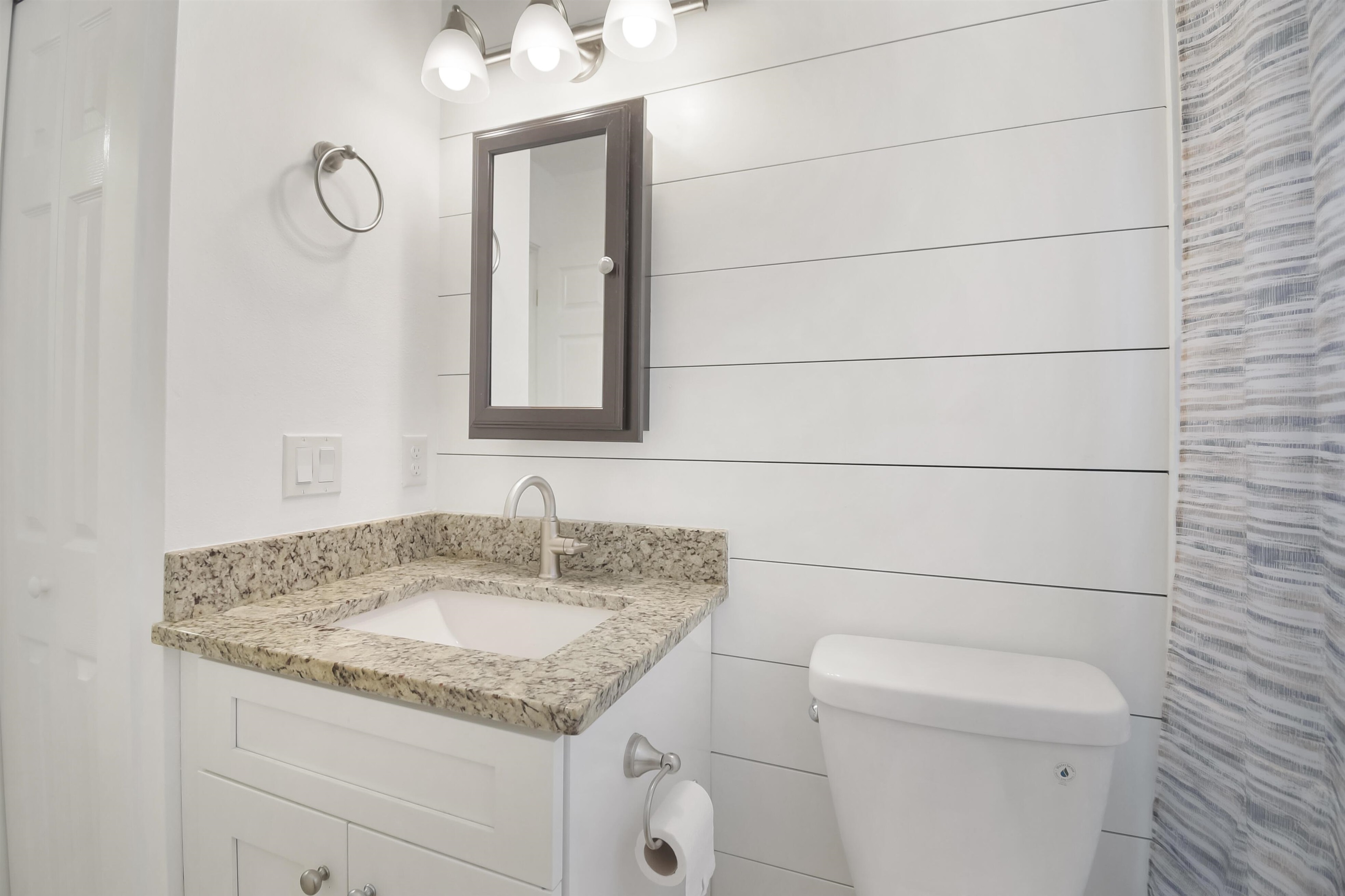 497 Pyrus Street St. Augustine, FL 32080 - Photo 21 of 36 a bathroom with a granite countertop sink and a toilet