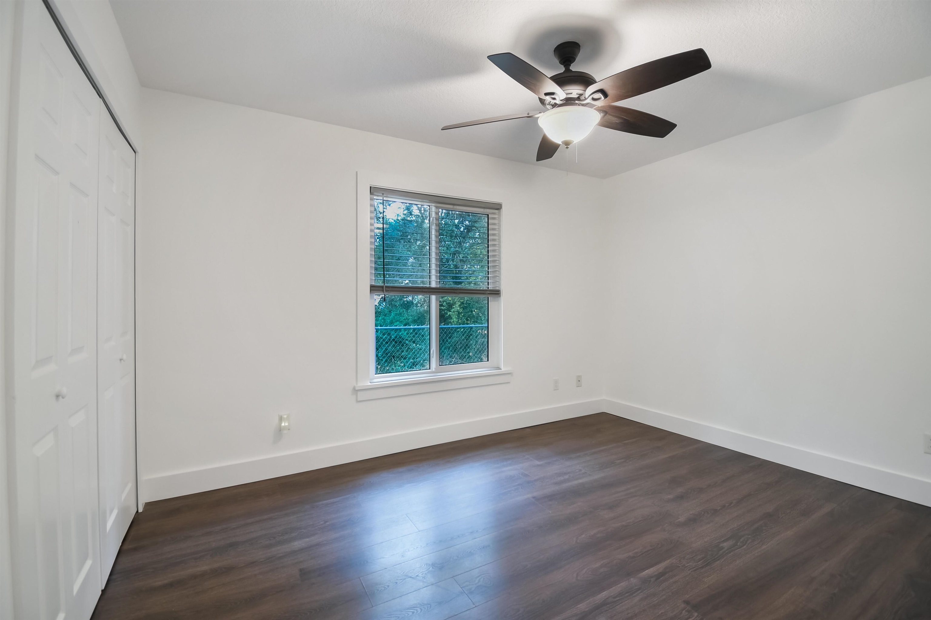 497 Pyrus Street St. Augustine, FL 32080 - Photo 22 of 36 Unfurnished bedroom featuring dark wood-style flooring, a closet, and a ceiling fan