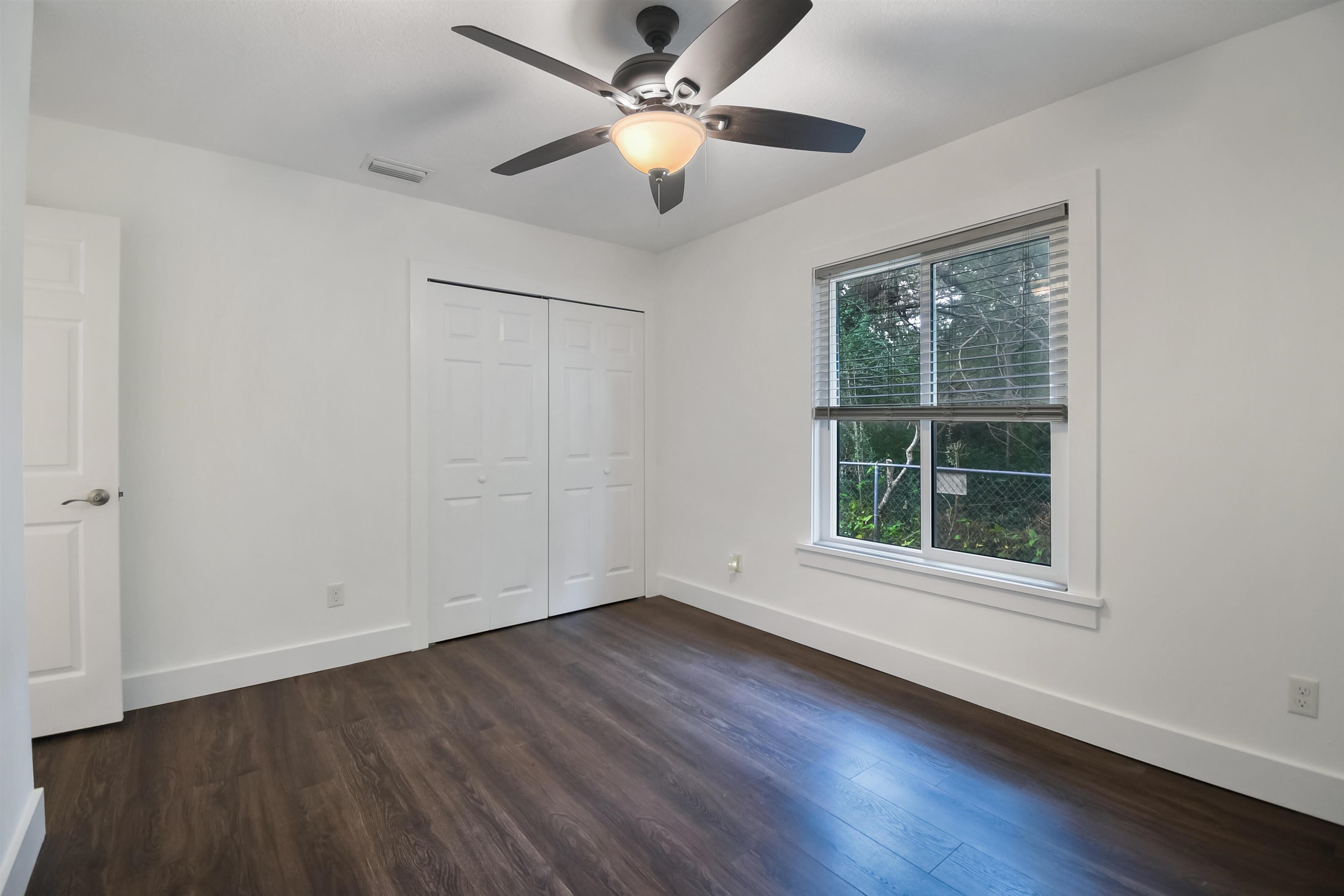 497 Pyrus Street St. Augustine, FL 32080 - Photo 23 of 36 a view of an empty room with wooden floor and a window