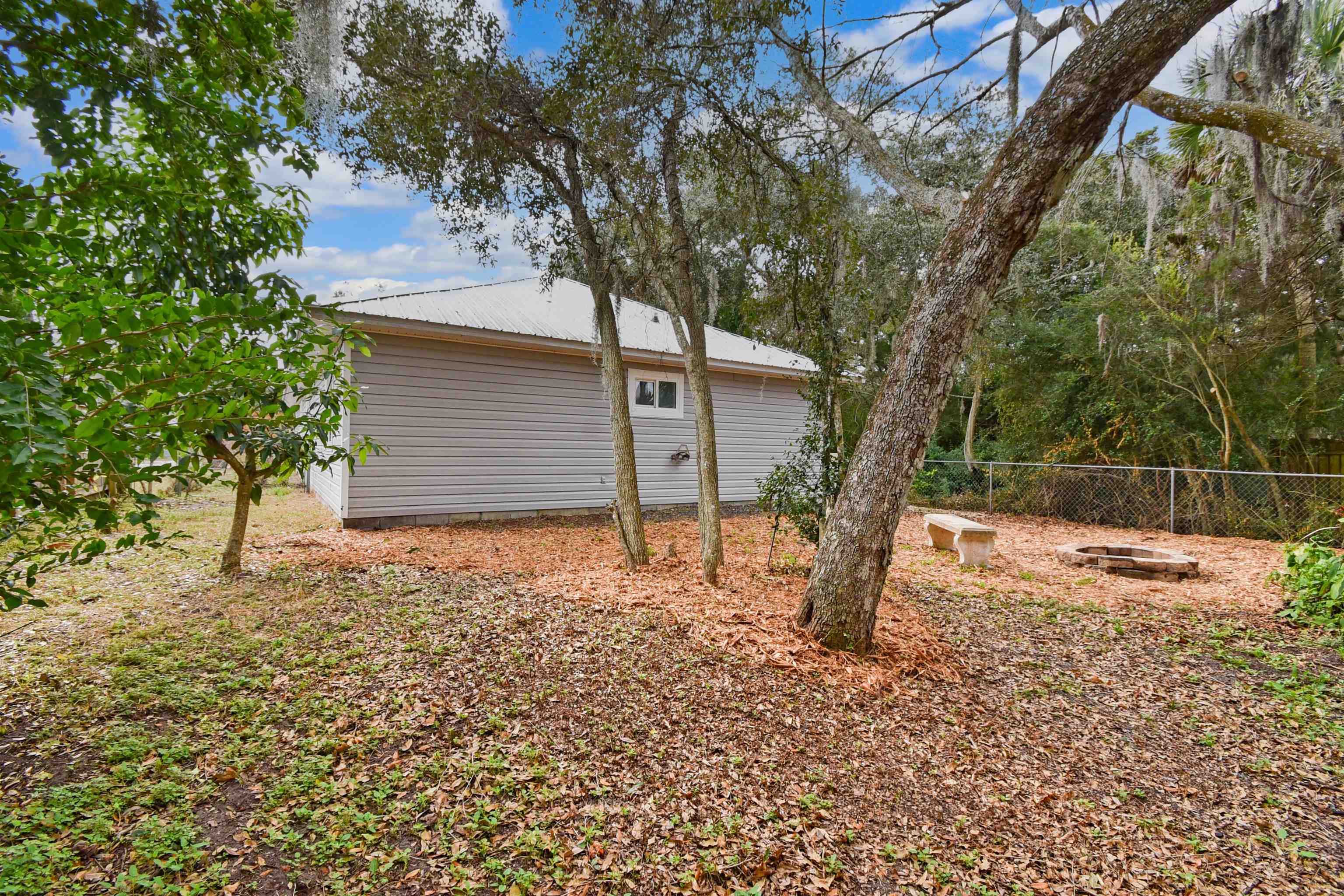 497 Pyrus Street St. Augustine, FL 32080 - Photo 31 of 36 a backyard of a house with lots of green space