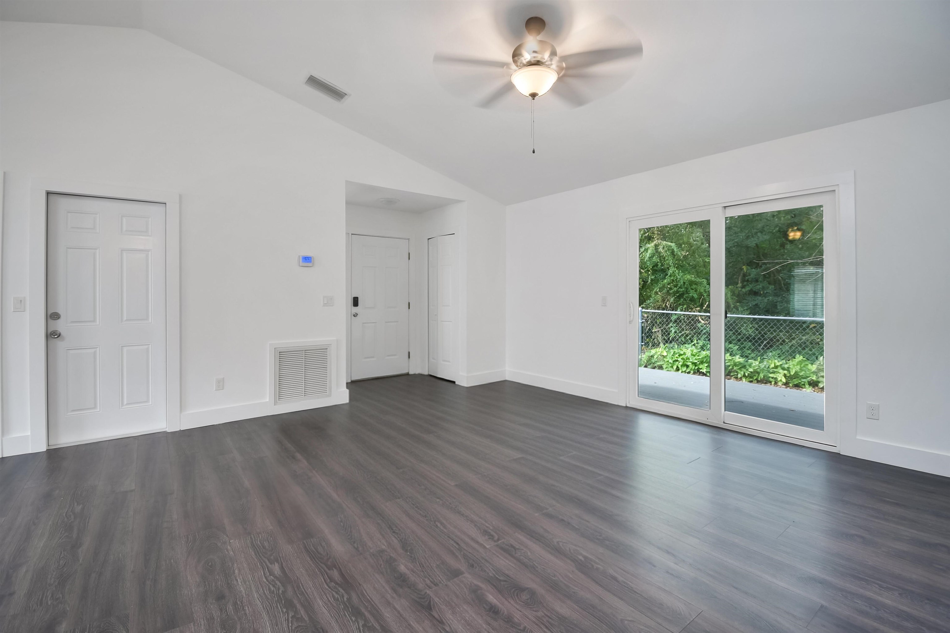 497 Pyrus Street St. Augustine, FL 32080 - Photo 5 of 36 Spare room featuring lofted ceiling, dark wood-style floors, and a ceiling fan