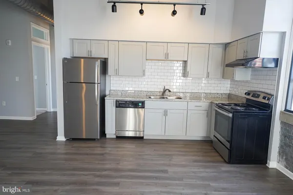 a kitchen with a sink and cabinets