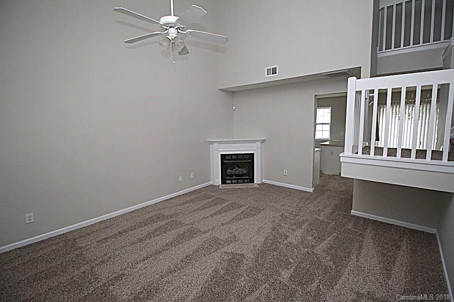 10503 Prairie Ridge Lane Charlotte, NC 28213 - Photo 2 of 9 a view of a livingroom with a ceiling fan window and a fireplace