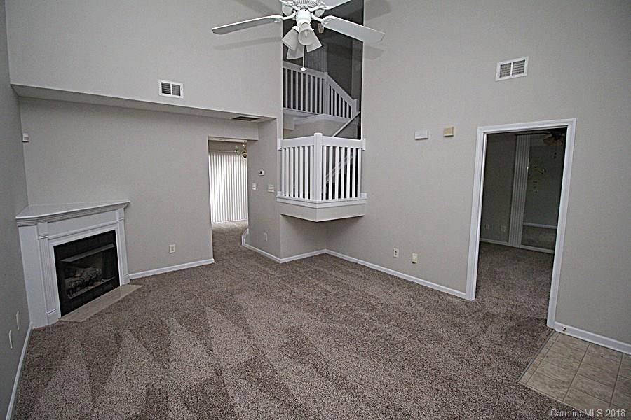 10503 Prairie Ridge Lane Charlotte, NC 28213 - Photo 3 of 9 a view of a livingroom with a fireplace and stairs