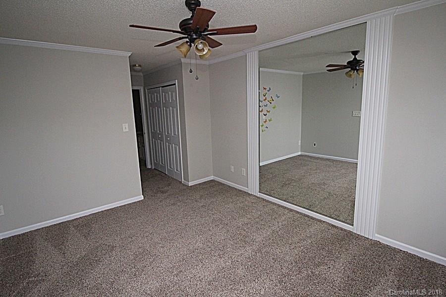 10503 Prairie Ridge Lane Charlotte, NC 28213 - Photo 5 of 9 an empty room and chandelier fan