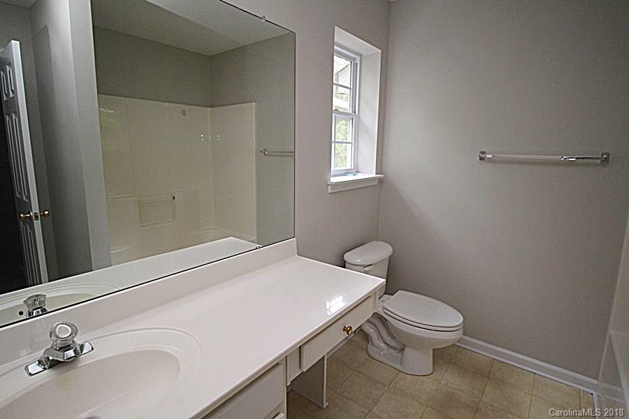 10503 Prairie Ridge Lane Charlotte, NC 28213 - Photo 7 of 9 a bathroom with a sink a toilet and a mirror