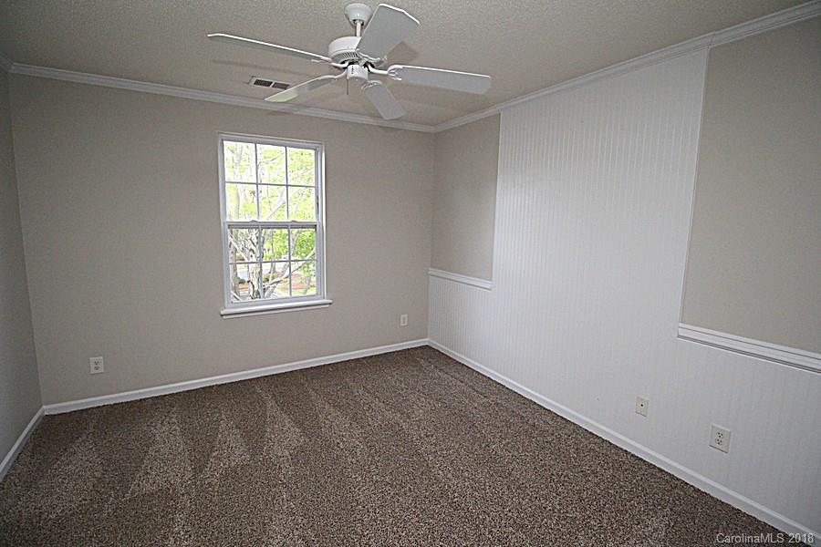 10503 Prairie Ridge Lane Charlotte, NC 28213 - Photo 9 of 9 an empty room with a window and ceiling fan