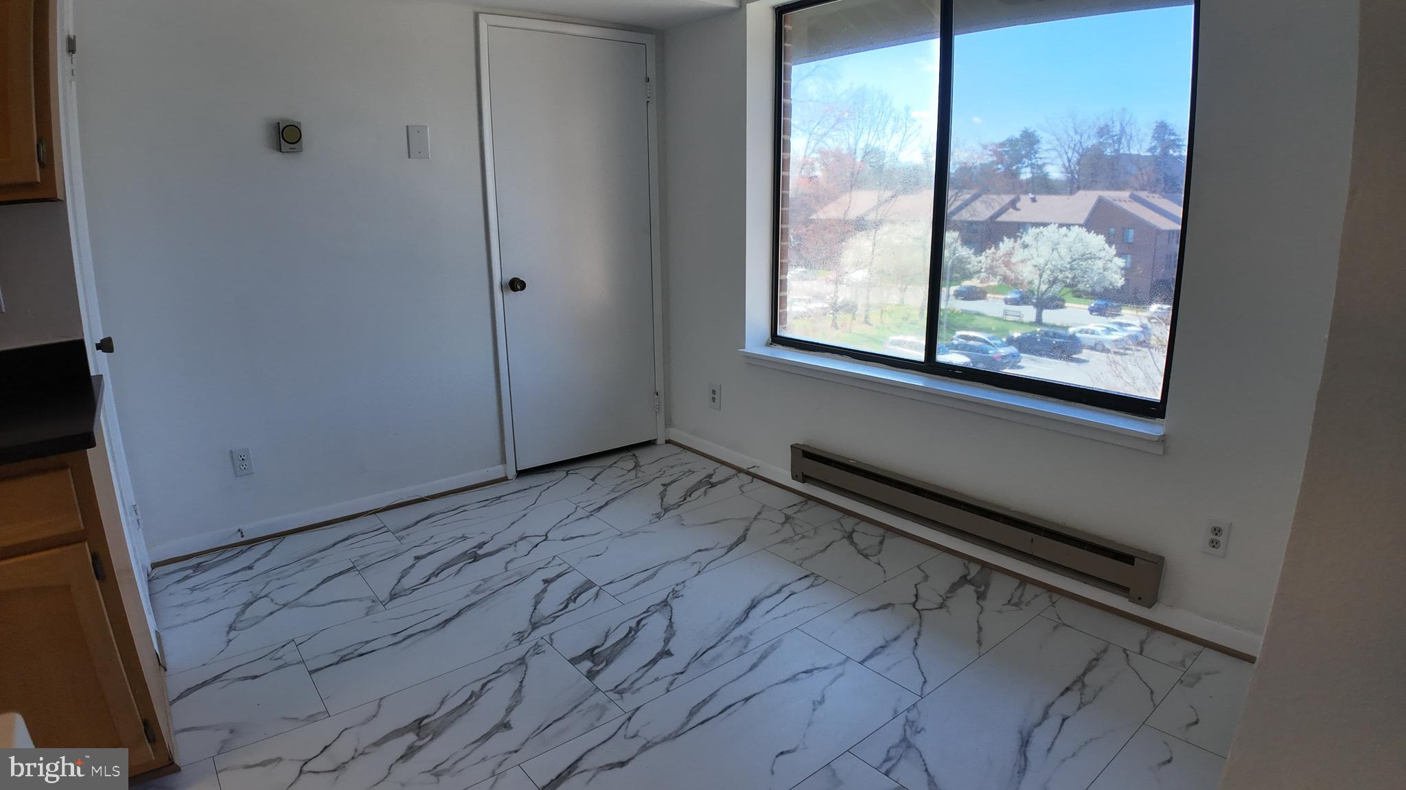 15311 Beaverbrook Court, Unit 903B Silver Spring, MD 20906 - Photo 17 of 36 a view of a room with wooden floor and windows