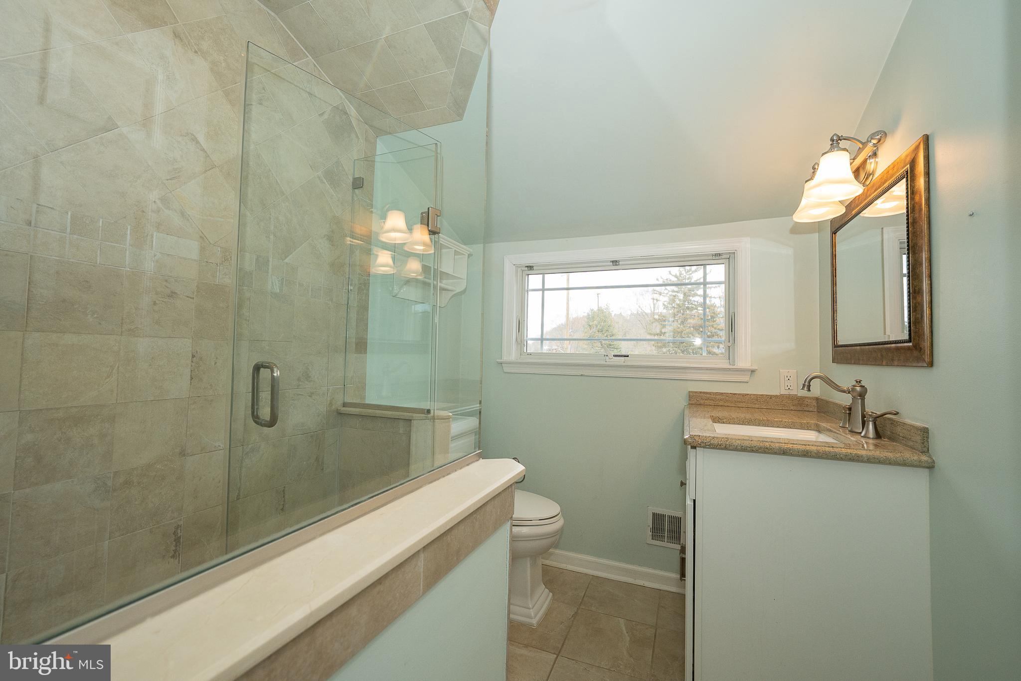 809 Matsons Ford Road Villanova, PA 19085 - Photo 13 of 24 a bathroom with a sink and mirror with toilet