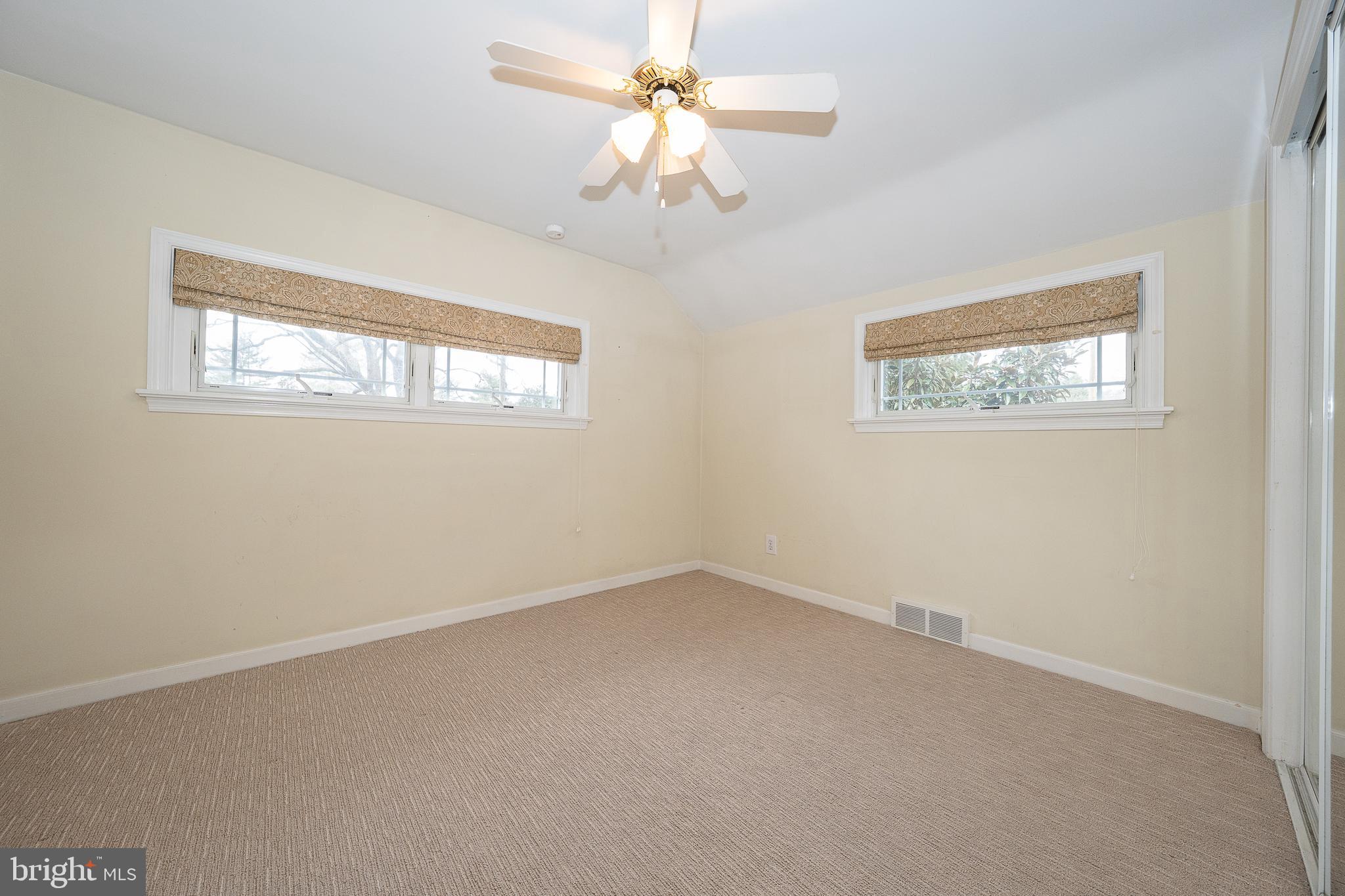 809 Matsons Ford Road Villanova, PA 19085 - Photo 15 of 24 an empty room with a chandelier fan and windows