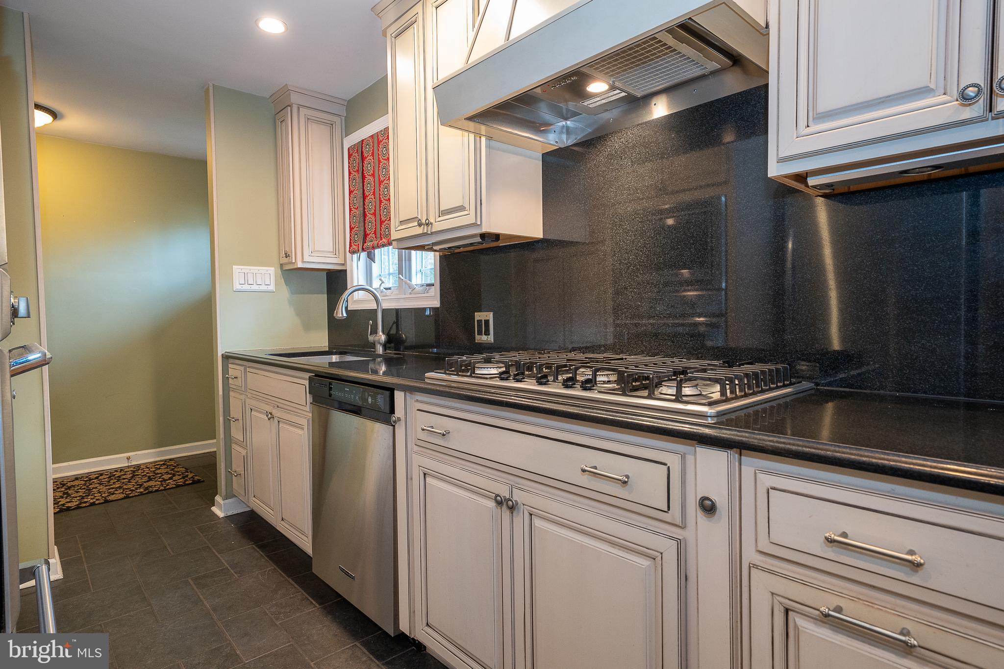 809 Matsons Ford Road Villanova, PA 19085 - Photo 7 of 24 a kitchen with a stove and white cabinets