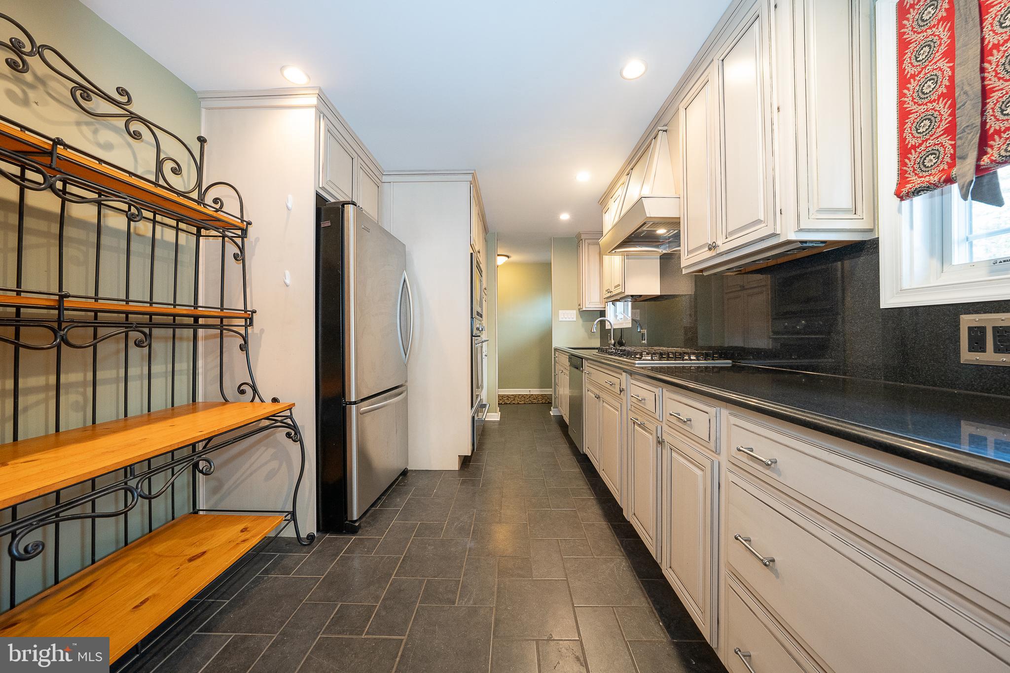 809 Matsons Ford Road Villanova, PA 19085 - Photo 8 of 24 a large kitchen with stainless steel appliances kitchen island granite countertop a refrigerator and a stove top oven