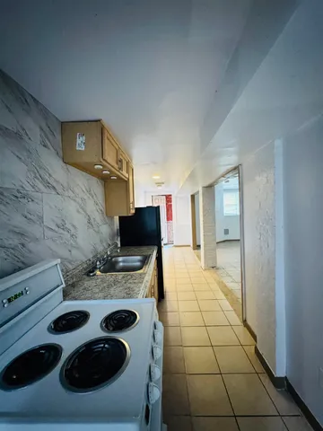 a bathroom with a granite countertop toilet and a shower