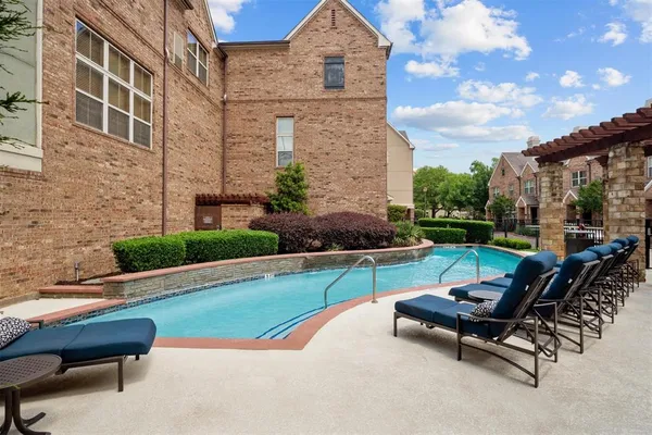 a swimming pool with outdoor seating and garden