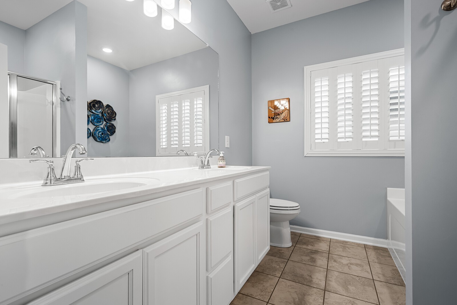 6004 Venable Court Fairview, TN 37062 - Photo 11 of 27 a bathroom with a double vanity sink a toilet and a mirror