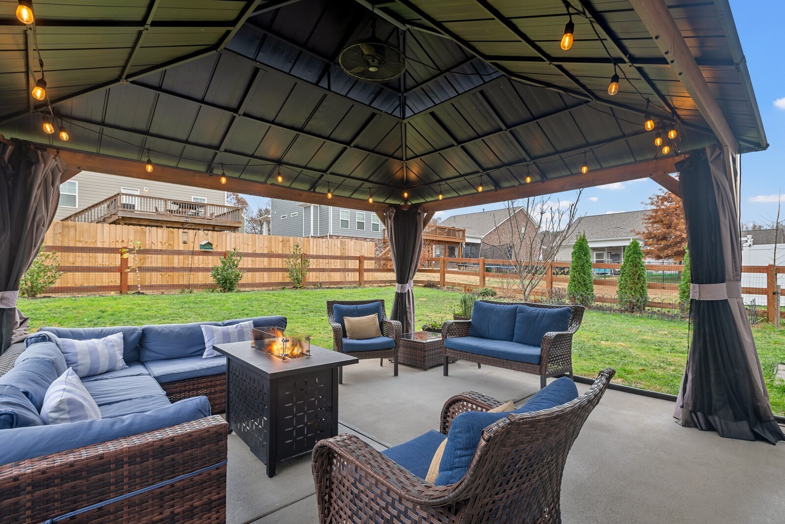 6004 Venable Court Fairview, TN 37062 - Photo 22 of 27 a view of a patio with couches chairs and a big yard