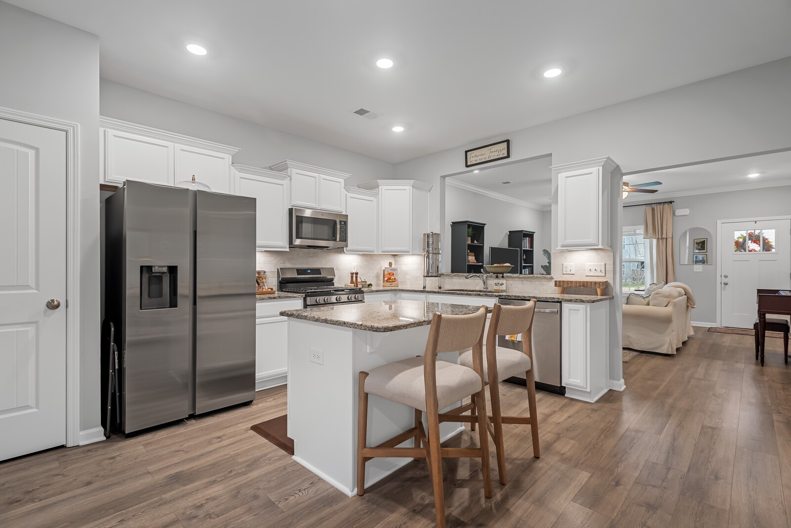 6004 Venable Court Fairview, TN 37062 - Photo 4 of 27 a kitchen with white cabinets and stainless steel appliances