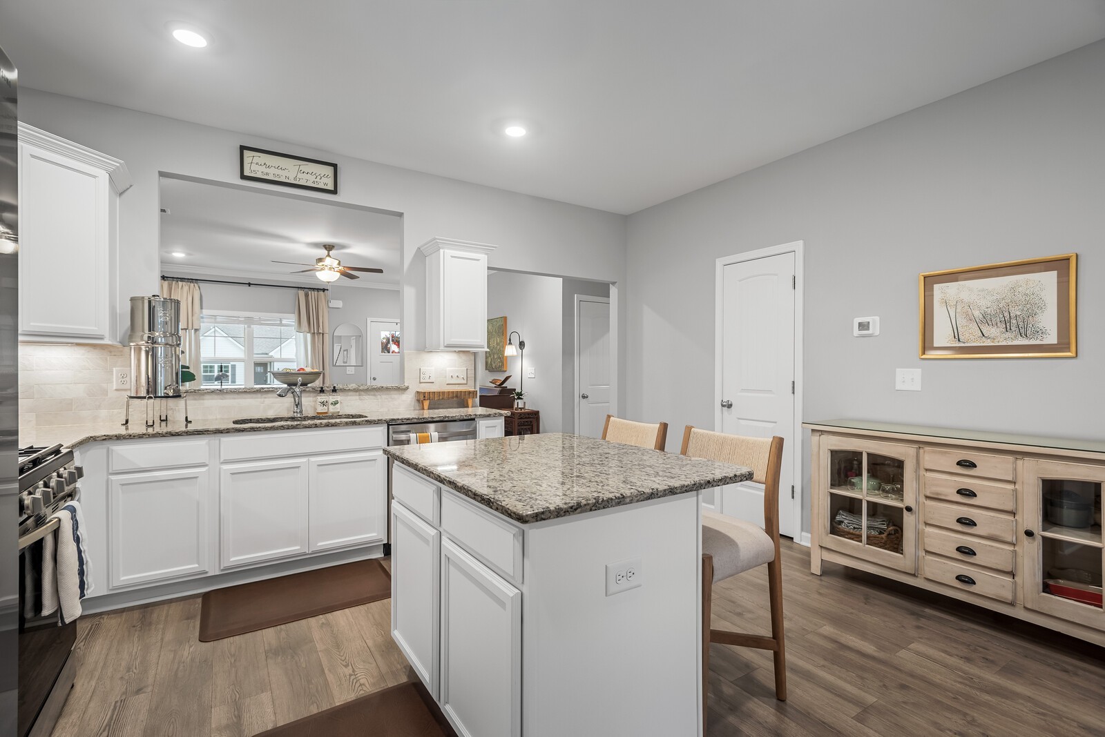 6004 Venable Court Fairview, TN 37062 - Photo 6 of 27 a kitchen with stainless steel appliances granite countertop a lot of counter space and wooden floors