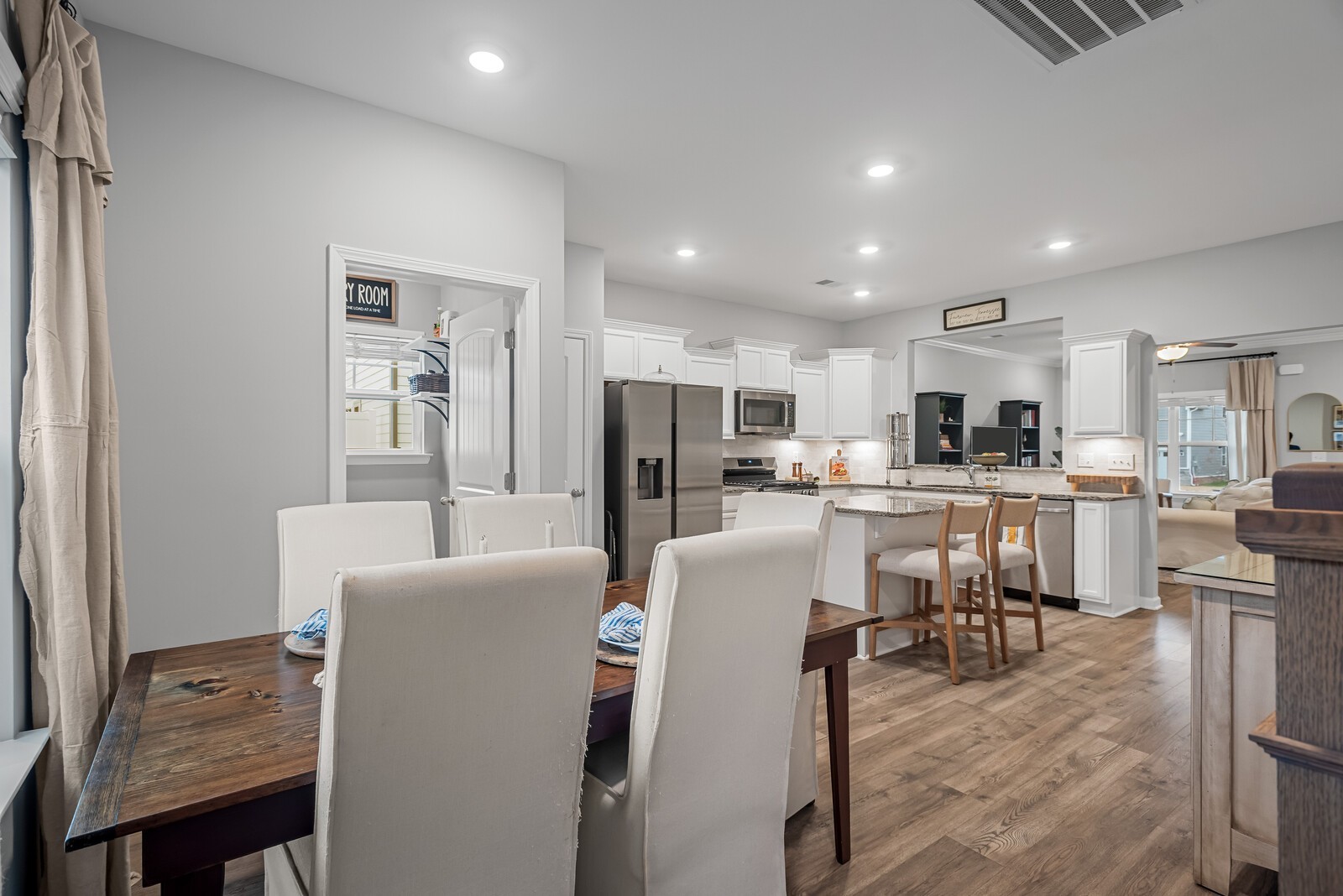 6004 Venable Court Fairview, TN 37062 - Photo 8 of 27 a living room with furniture a kitchen view and a refrigerator