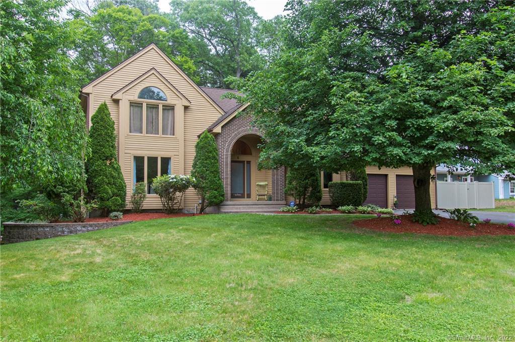 6 Merriman Road Windsor, CT 06095 - Photo 1 of 1 a front view of a house with a garden and trees