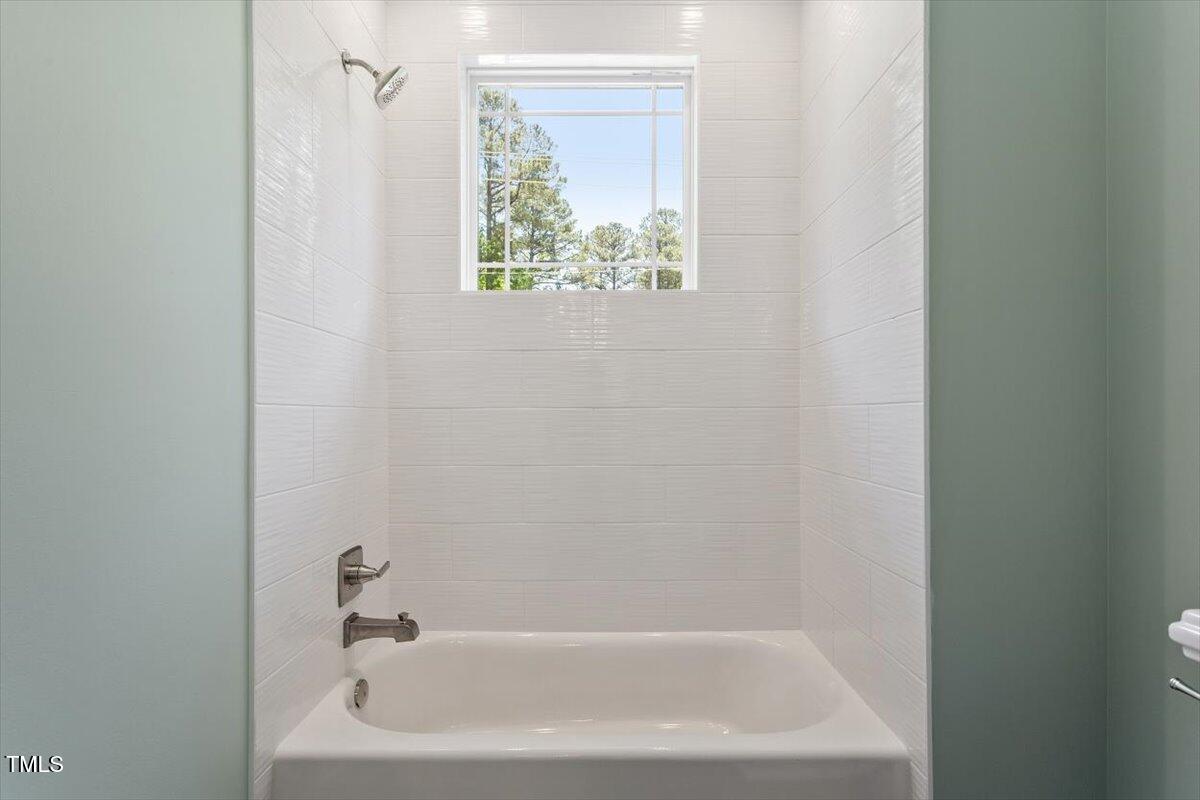 3934 Old Chapel Hill Road Durham, NC 27707 - Photo 36 of 47 a close up of a bathtub in a bathroom