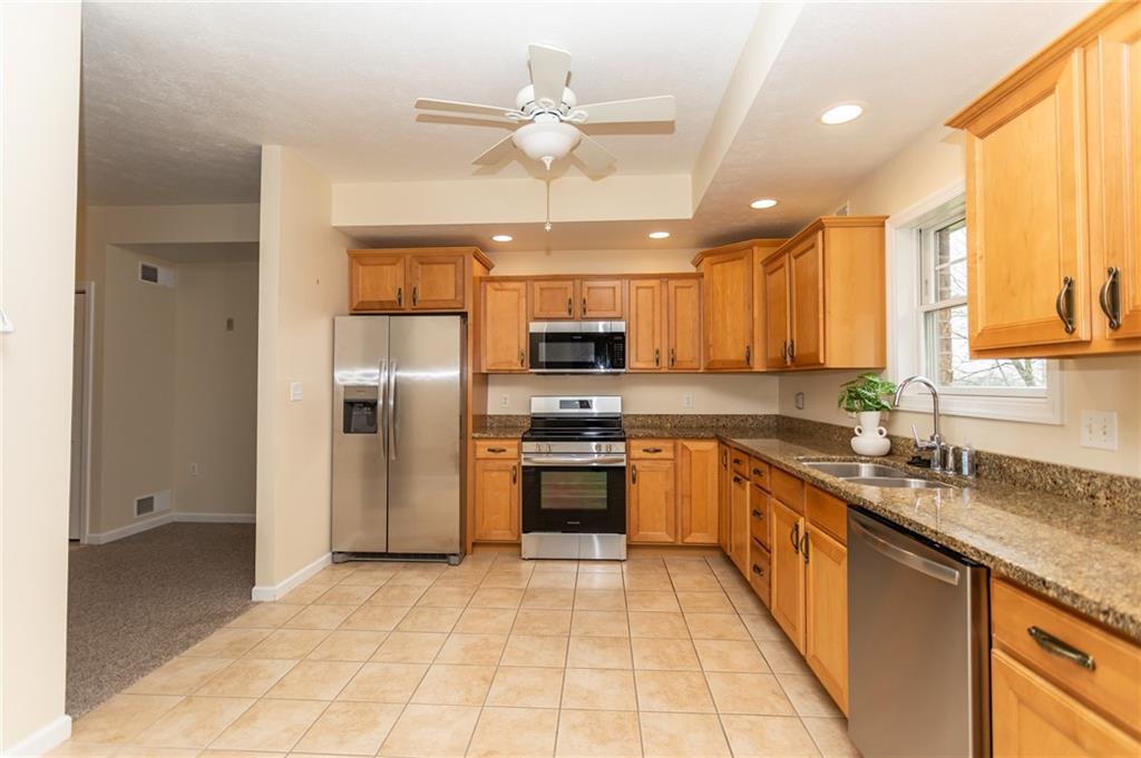 320 Dixon Boulevard Uniontown, PA 15401 - Photo 12 of 31 a large kitchen with stainless steel appliances granite countertop a sink and cabinets