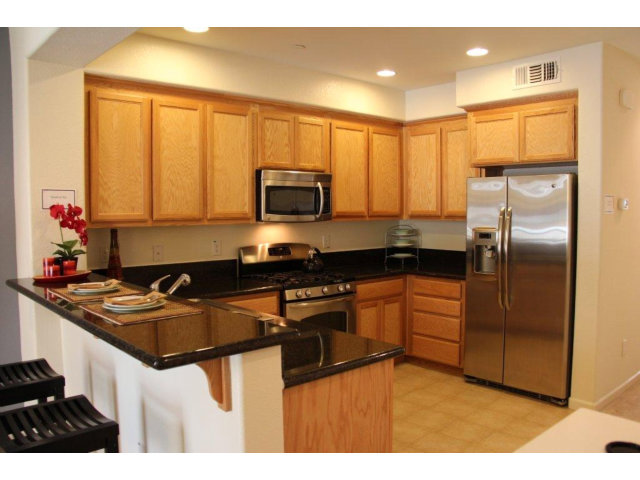 1812 Snell Place Milpitas, CA 95035 - Photo 4 of 19 a kitchen with kitchen island granite countertop a sink stove and refrigerator