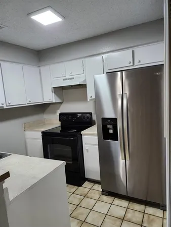 a kitchen with stainless steel appliances a refrigerator and a stove