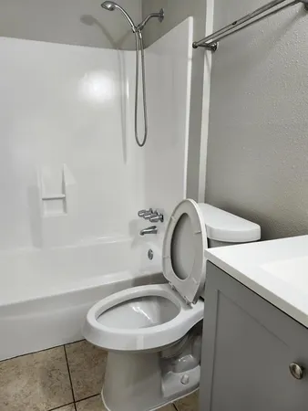 a bathroom with a sink mirror vanity and toilet