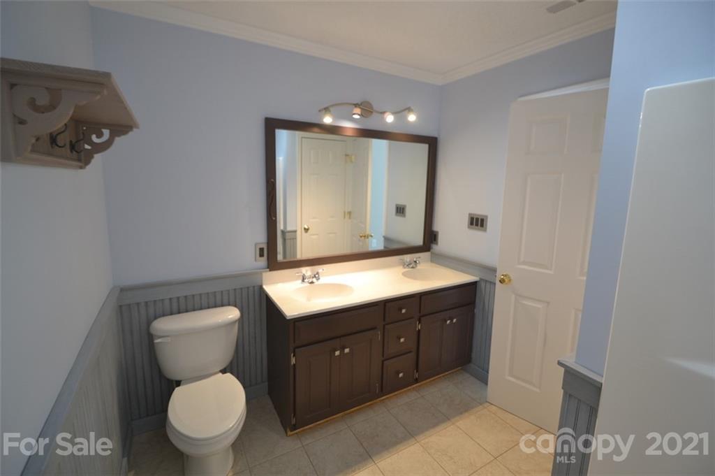 3622 Lee Moore Road Maiden, NC 28650 - Photo 12 of 34 a bathroom with a toilet sink vanity granite and mirror