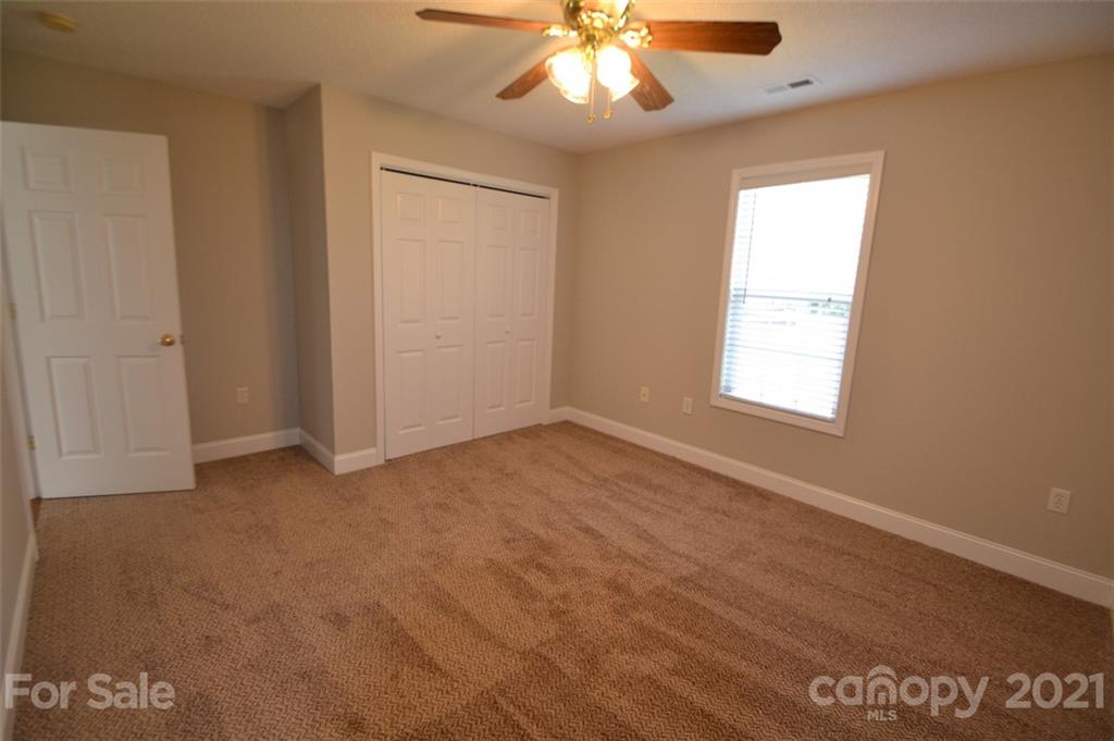 3622 Lee Moore Road Maiden, NC 28650 - Photo 17 of 34 an empty room with windows and fan