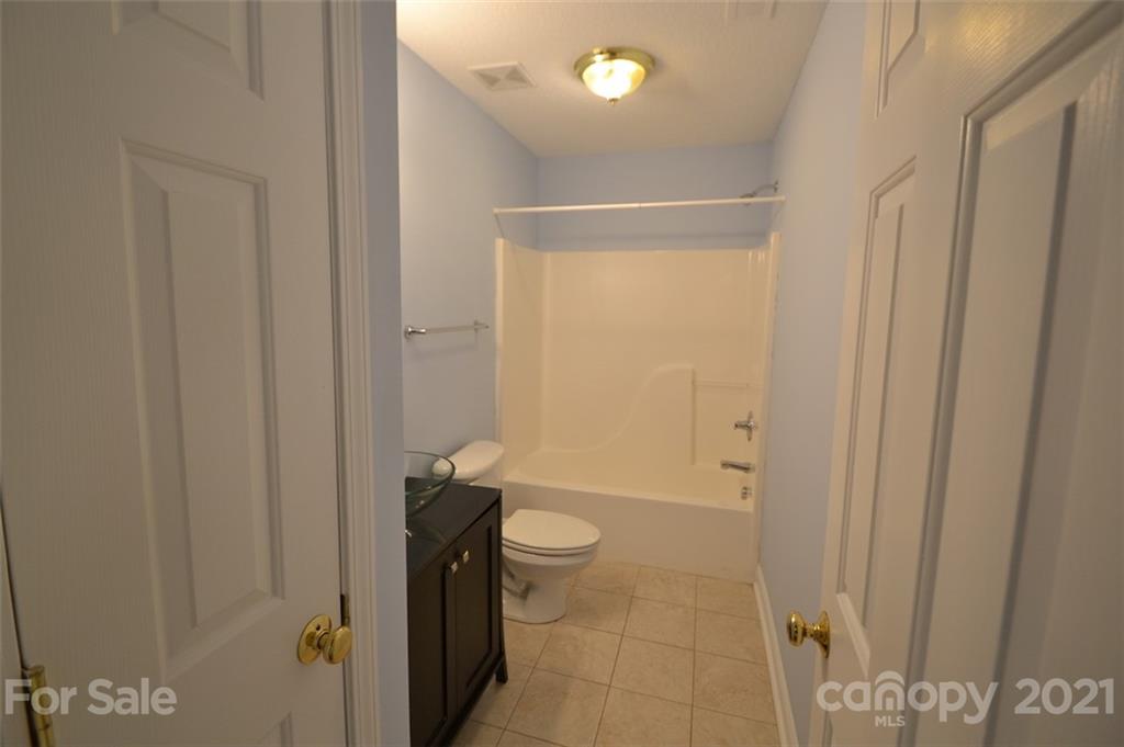 3622 Lee Moore Road Maiden, NC 28650 - Photo 18 of 34 a bathroom with a granite countertop toilet and a shower