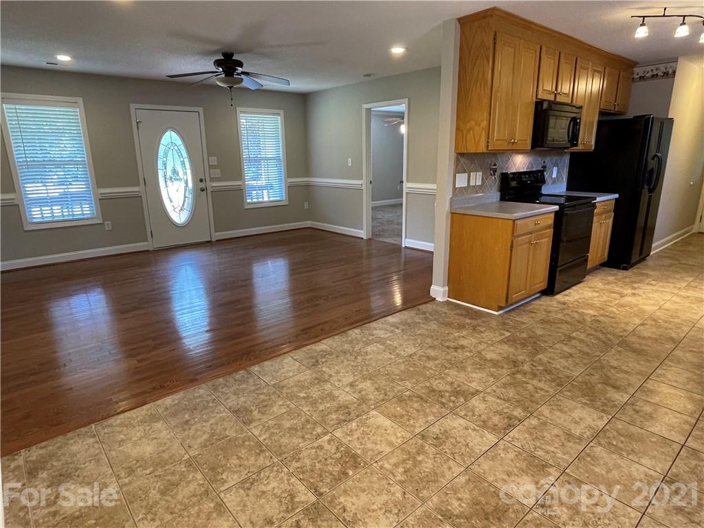 3622 Lee Moore Road Maiden, NC 28650 - Photo 5 of 34 a large kitchen with cabinets and wooden floor