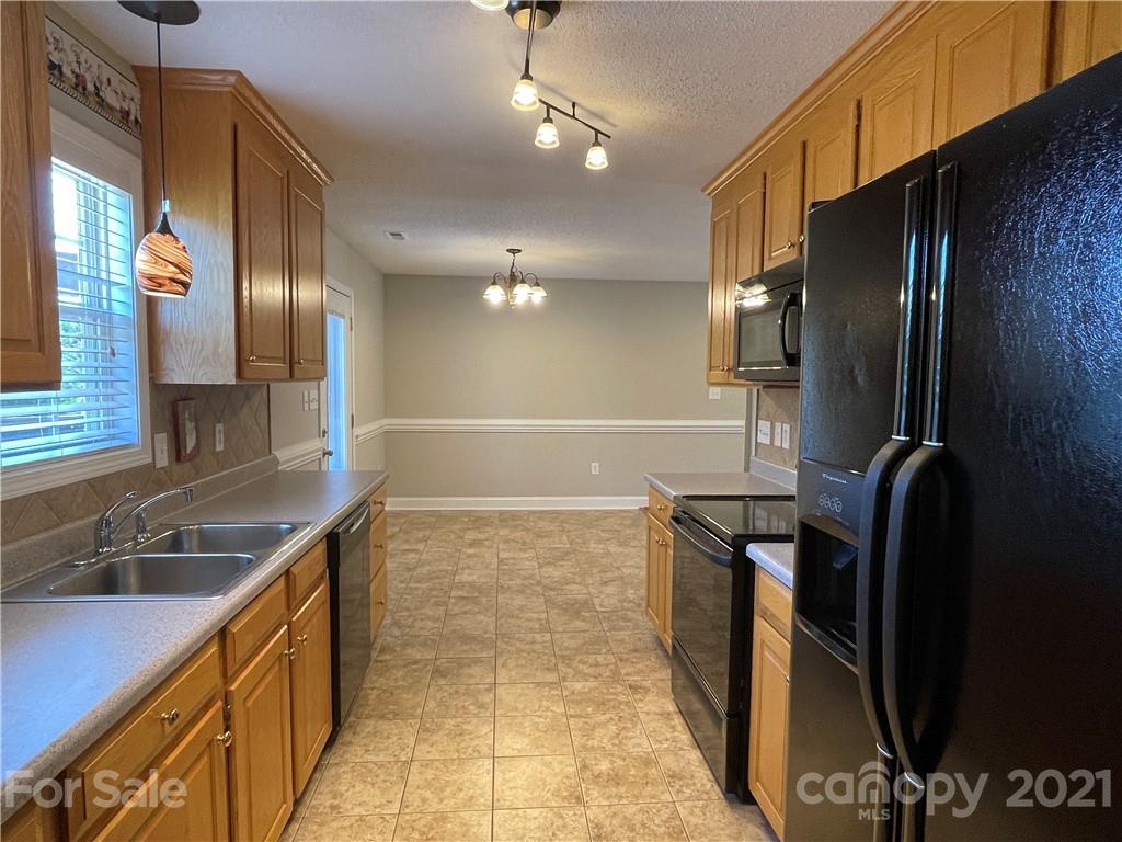 3622 Lee Moore Road Maiden, NC 28650 - Photo 8 of 34 a kitchen with granite countertop a refrigerator and a sink