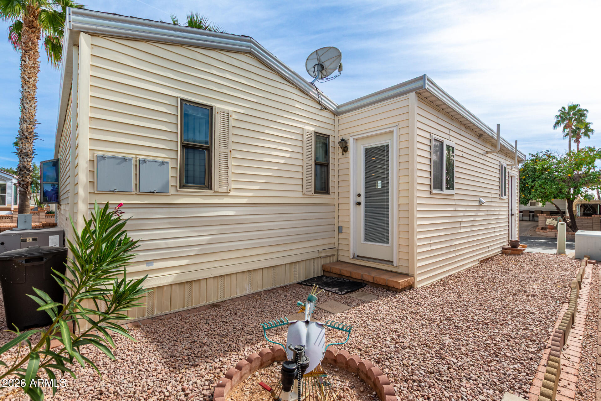 111 South Greenfield Road, Unit 547 Mesa, AZ 85206 - Photo 29 of 38 a view of a house with a small yard and large tree