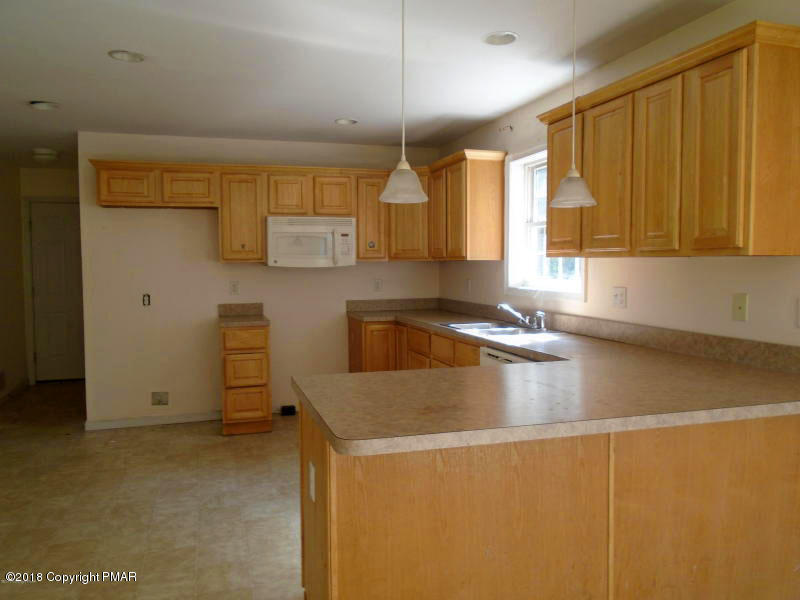 2164 Bushkill Circle Bushkill, PA 18324 - Photo 4 of 10 a kitchen with a sink a window and cabinets