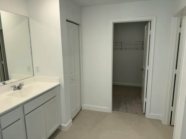 a bathroom with a sink and mirror