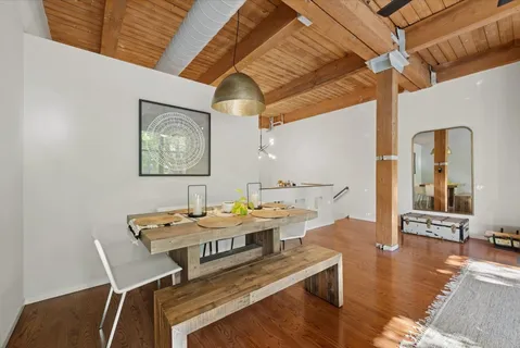 a dining room with furniture and wooden floor