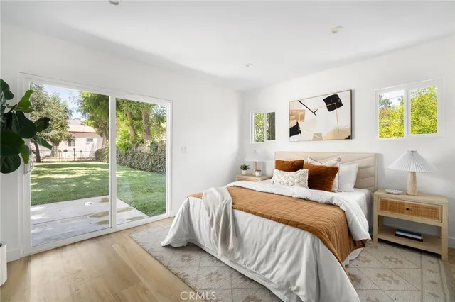 a bedroom with a bed and a large window