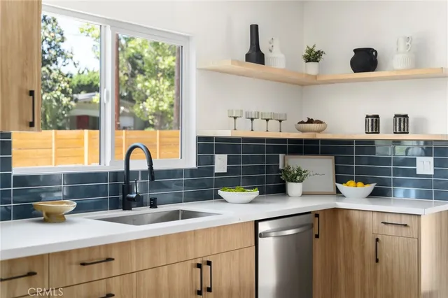 a kitchen with a sink a counter and cabinets