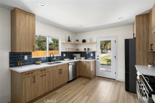 a kitchen with a sink stove and refrigerator