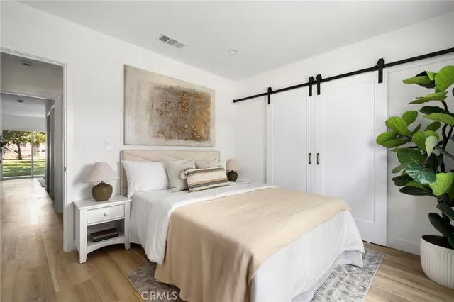 a bedroom with a bed and a potted plant