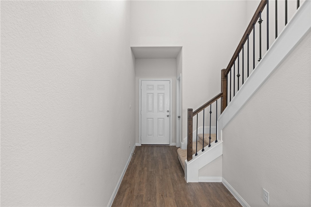 4702 Nopalitos Way Bryan, TX 77807 - Photo 7 of 27 a view of a hallway with wooden floor and entryway