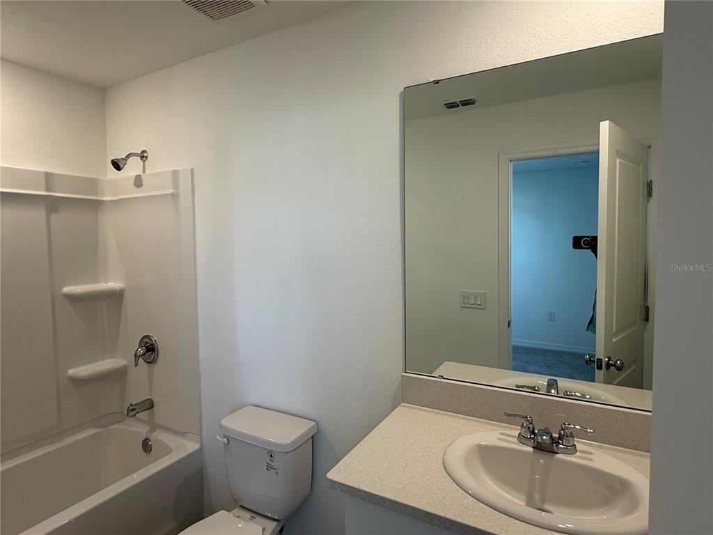 2980 Skyline Loop, Unit 2980 Kissimmee, FL 34758 - Photo 12 of 14 a bathroom with a sink toilet and shower