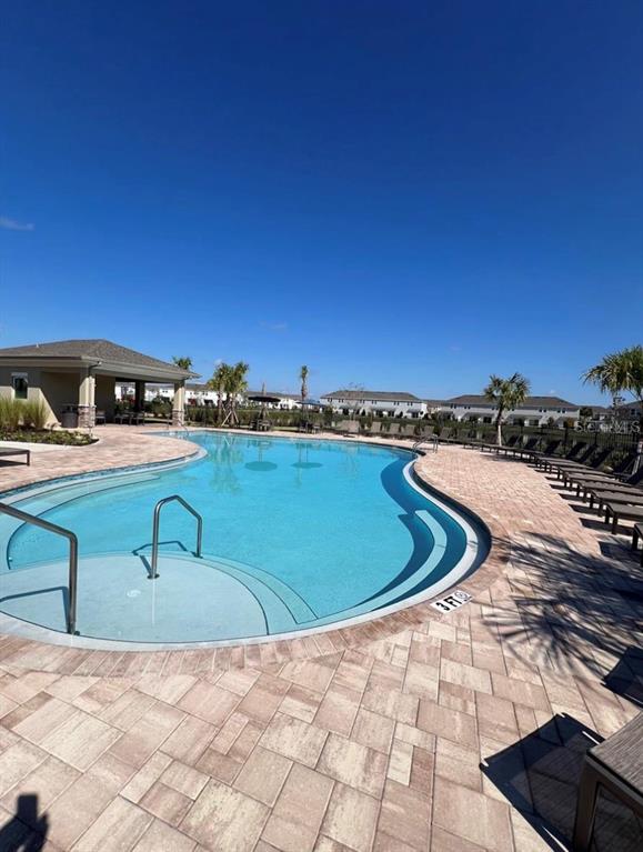 2980 Skyline Loop, Unit 2980 Kissimmee, FL 34758 - Photo 5 of 14 a view of a swimming pool with a chairs