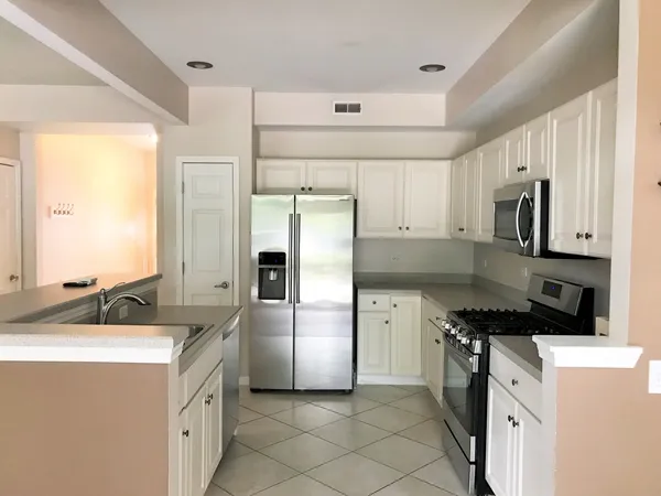 a kitchen with a sink appliances and cabinets