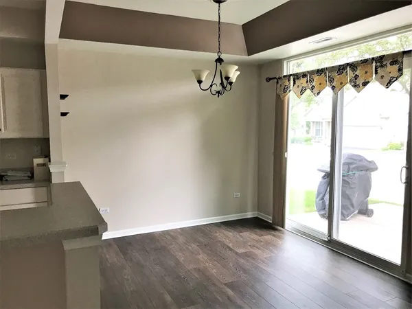 a view of a walk in closet with wooden floor