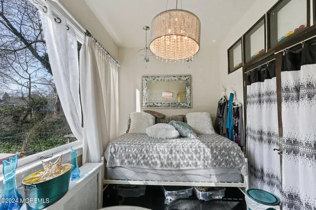 a bedroom with a bed and a chandelier