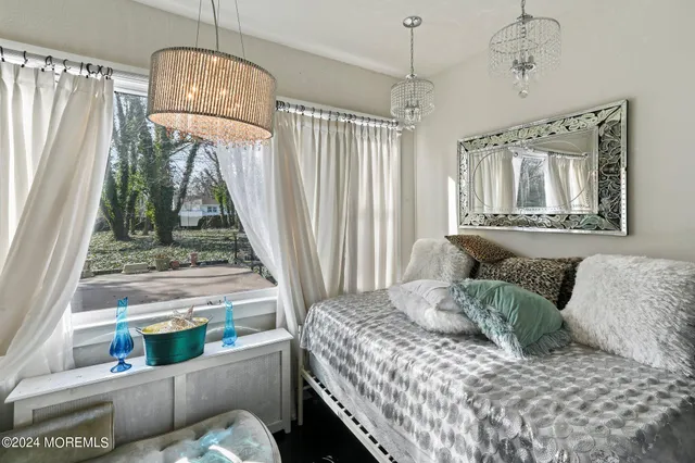 a bedroom with a bed and a chandelier
